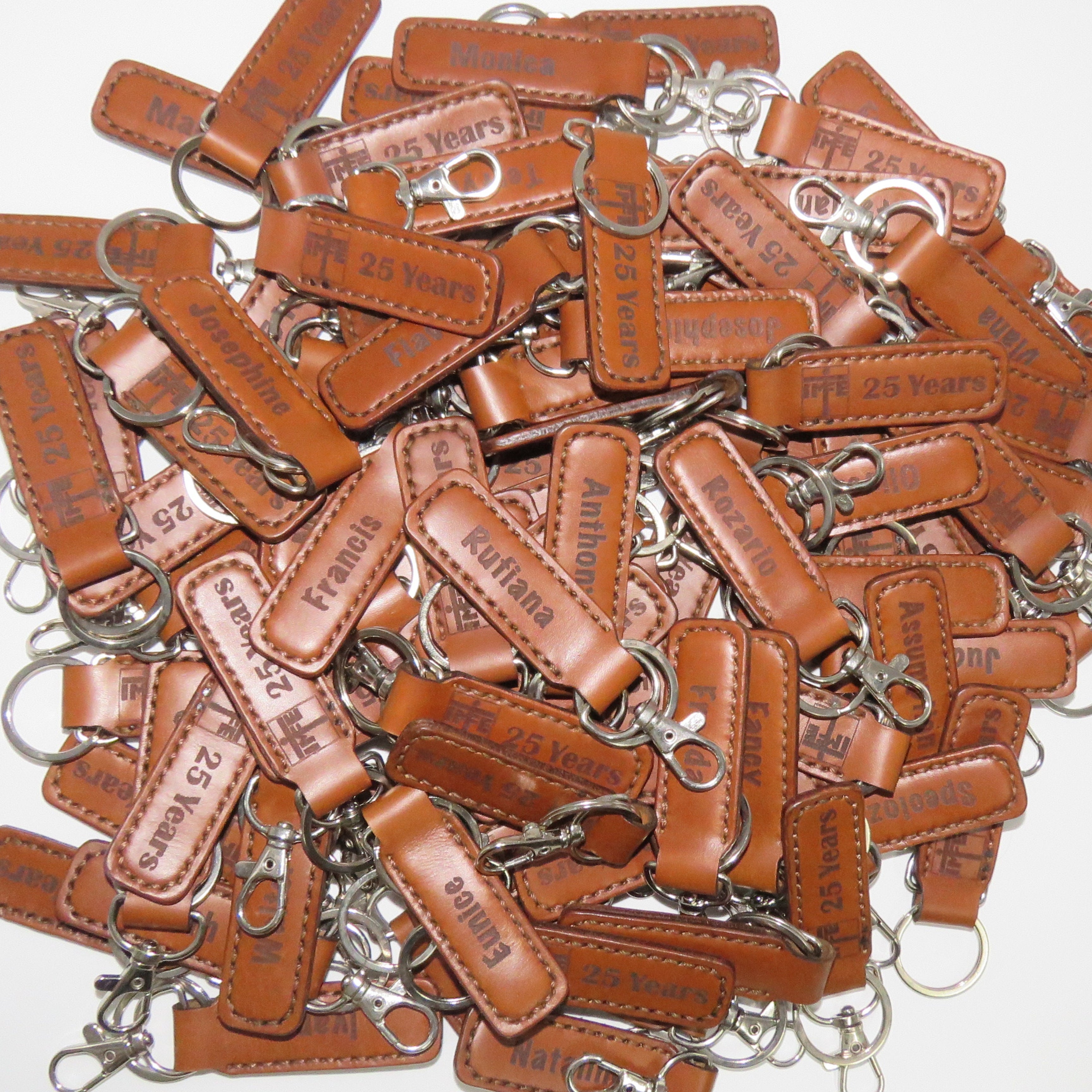 Collection of brown leather keychains on a white background