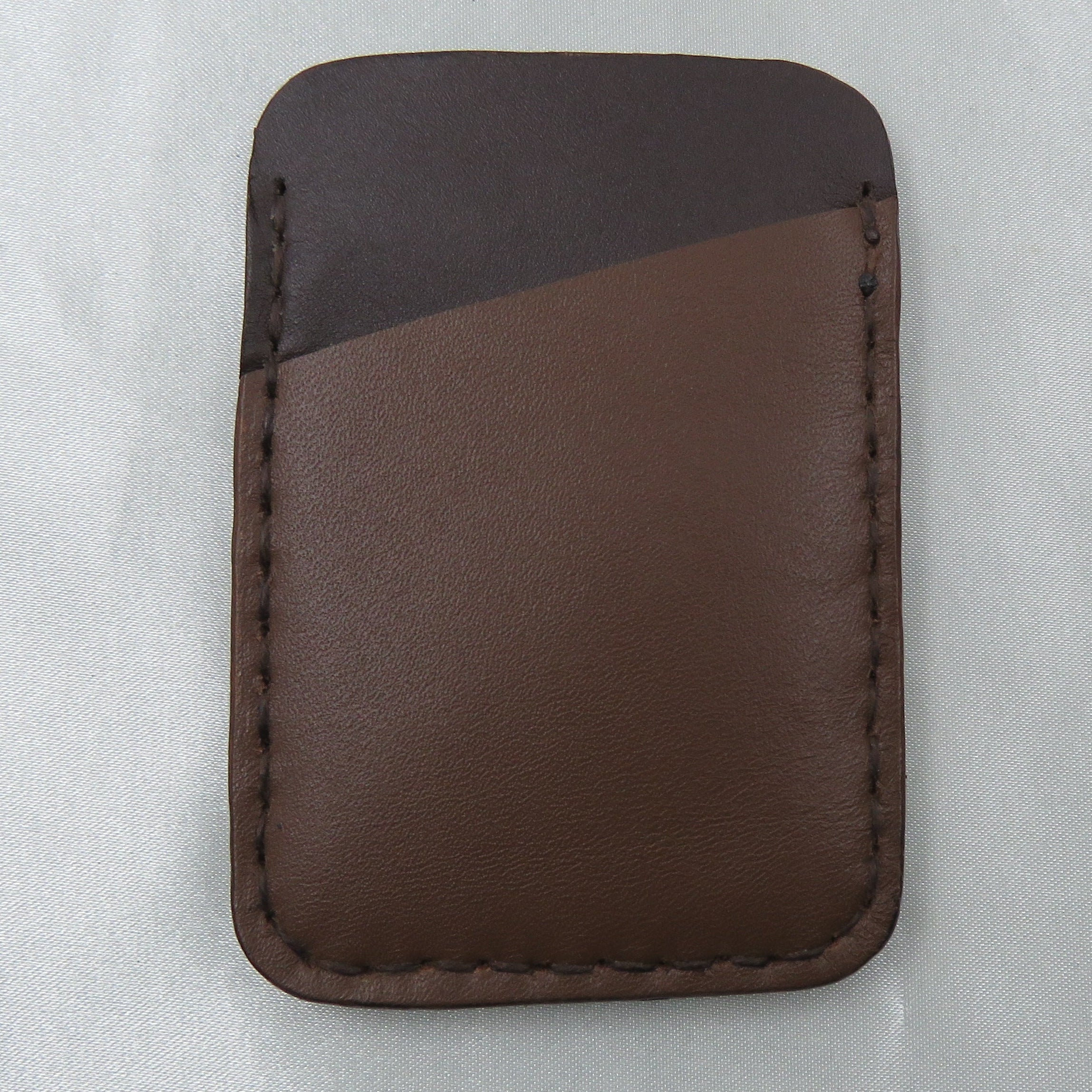 Brown leather cardholder on a white background