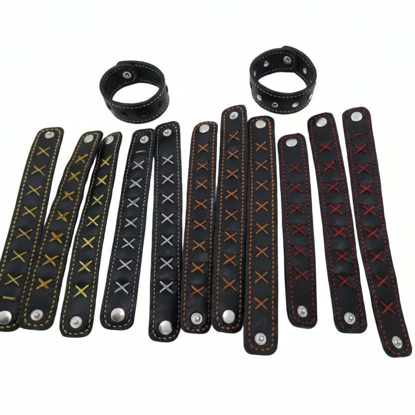Set of black leather wristbands with various patterns on a white background