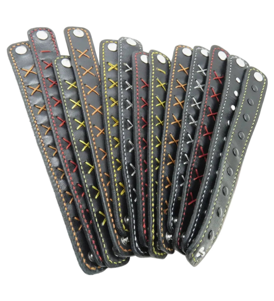 Set of gray leather straps with colorful stitching on a white background