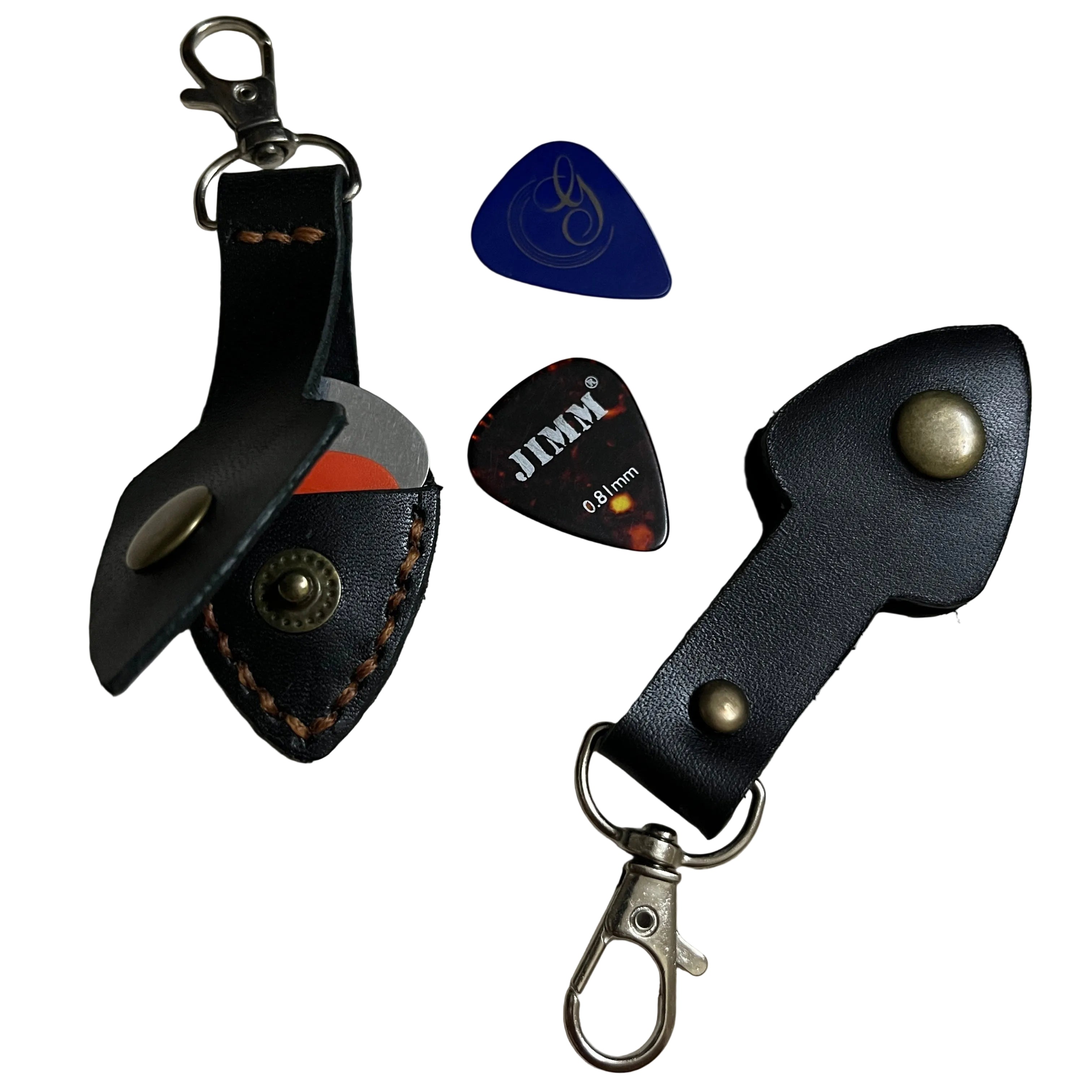 Two black leather keychains with metal clasps and two guitar picks on a light gray background.