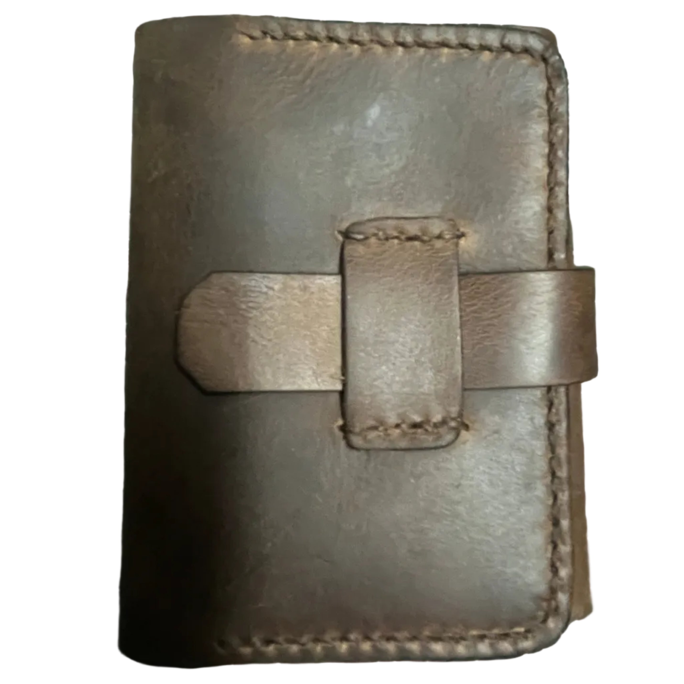 Brown leather wallet on a green cutting mat with grid lines