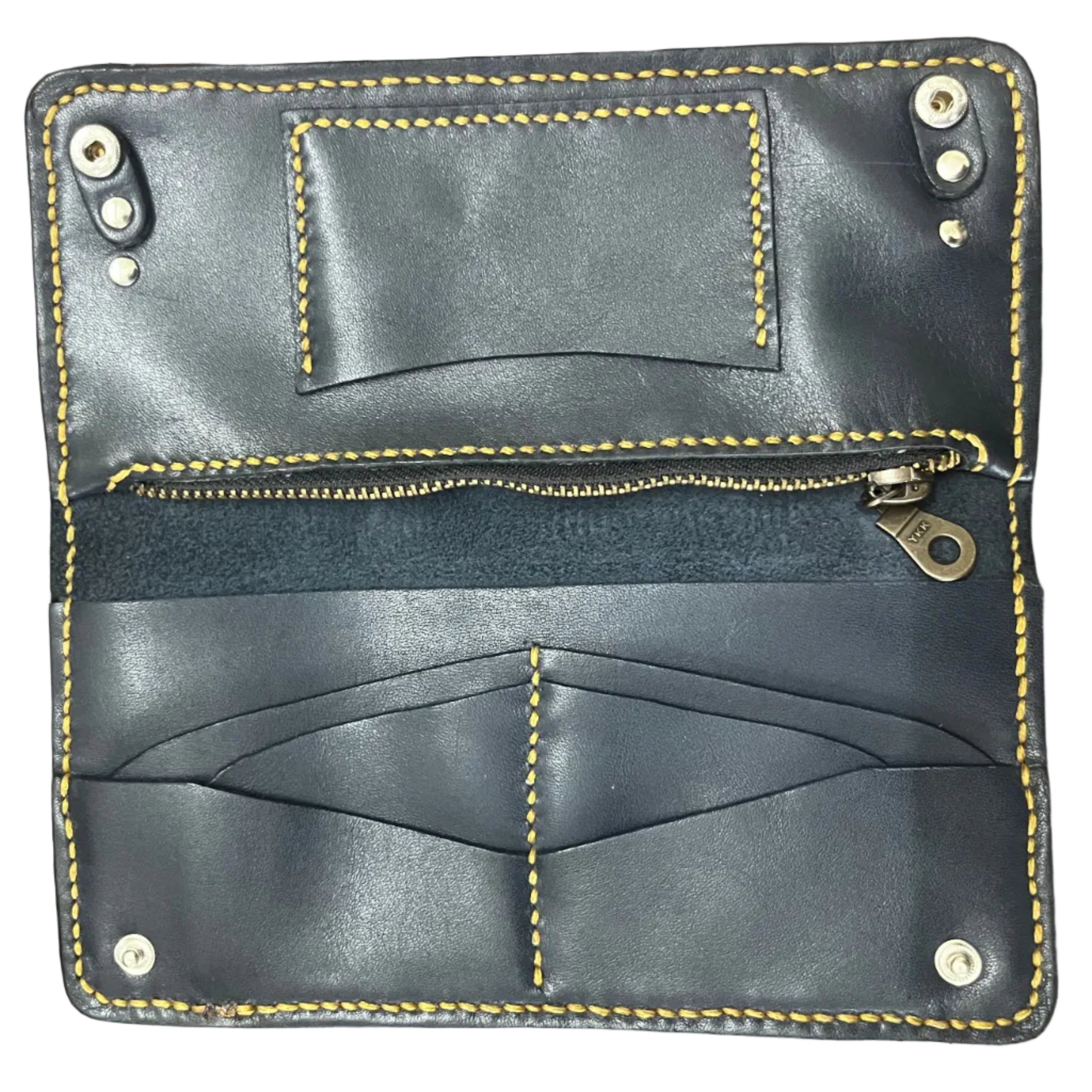 Black leather wallet with yellow stitching on a wooden surface