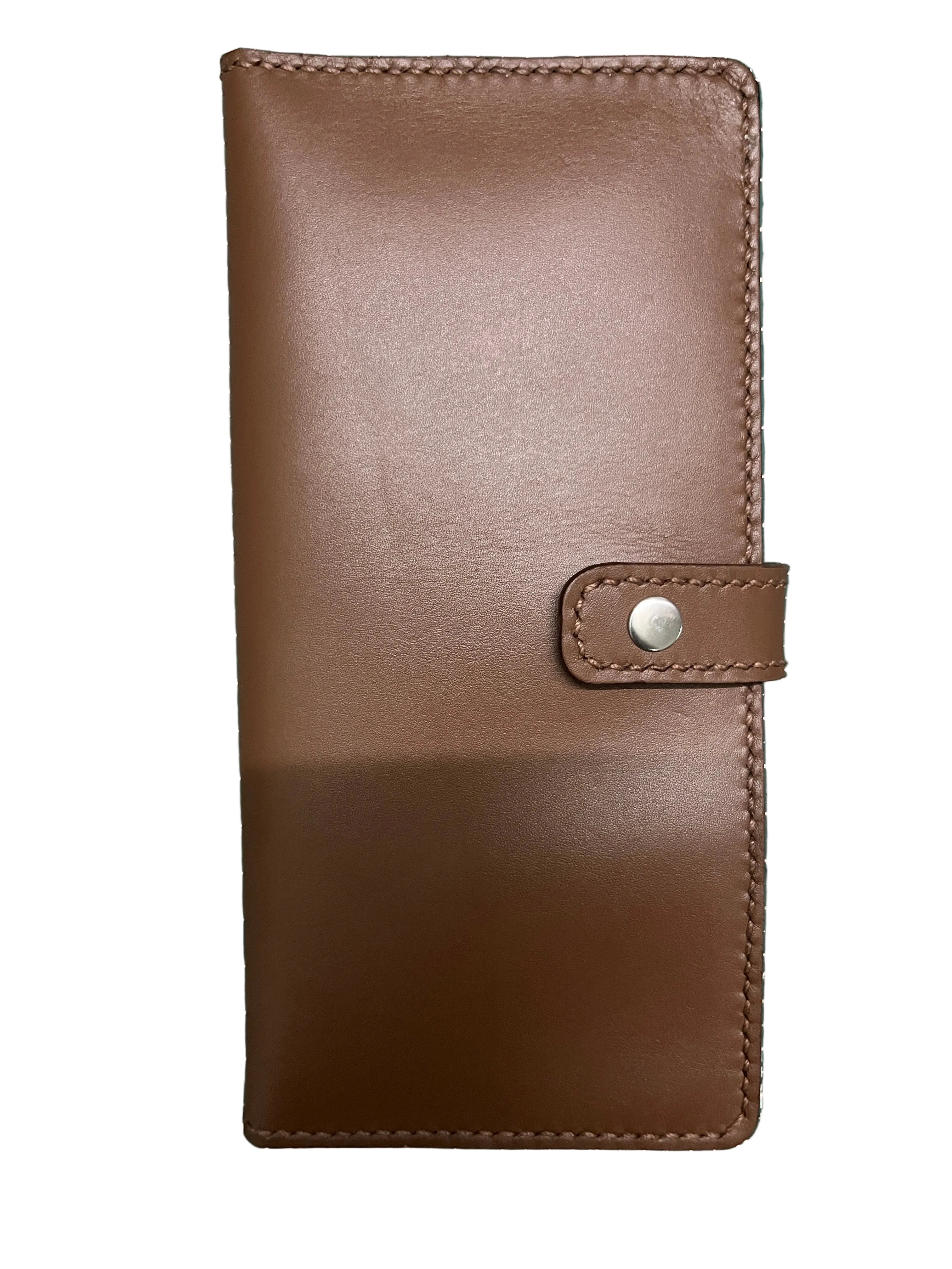 Brown leather wallet on a green grid background