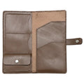 Brown leather wallet on a green cutting mat with grid lines