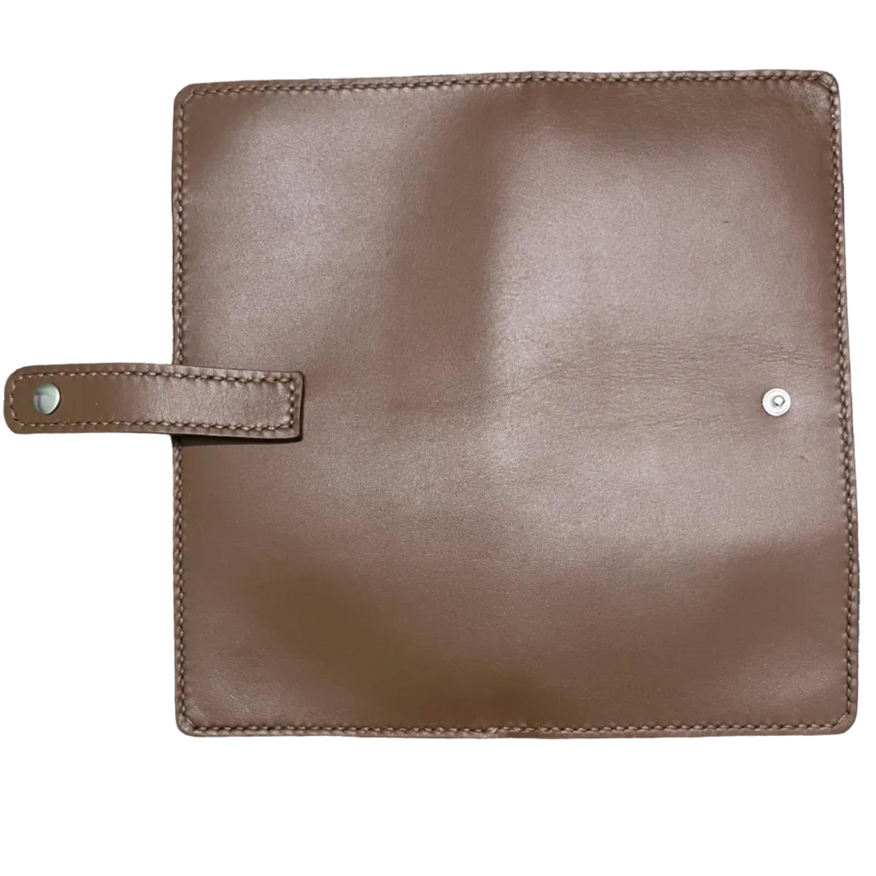 Brown leather pouch on a green cutting mat with grid lines