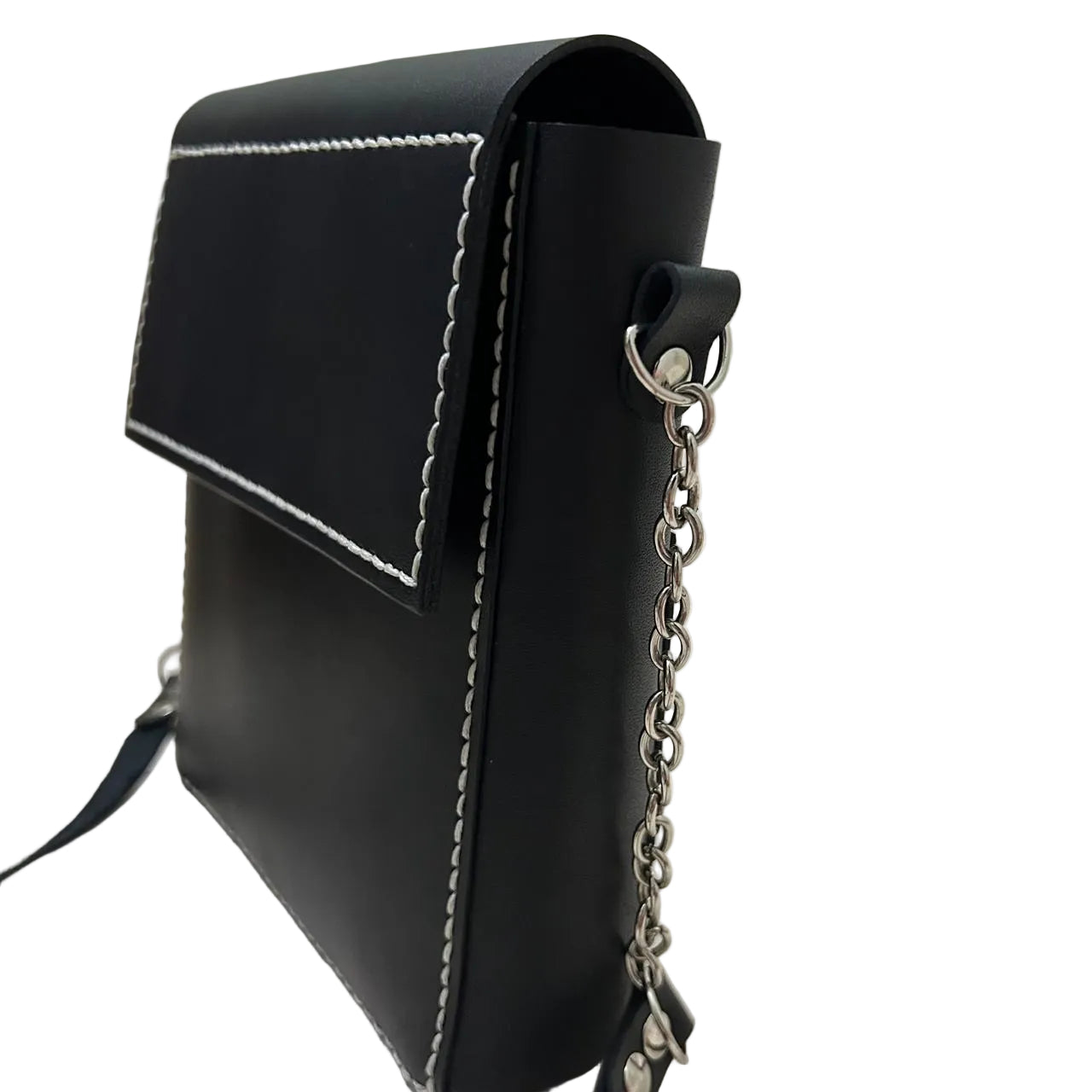Black handbag with chain detail on a light surface